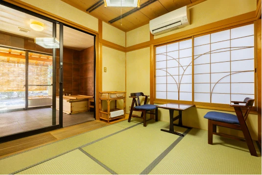 木の温もりと畳の香りに包まれた、心安らぐ客室。広々とした空間で、バリアフリー設計。段差のないスライドドアでスムーズに移動可能。